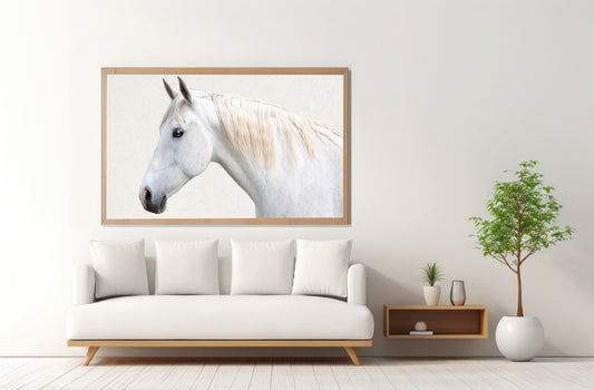 Framed artwork of a horse on a wall above a white sofa in a living room.